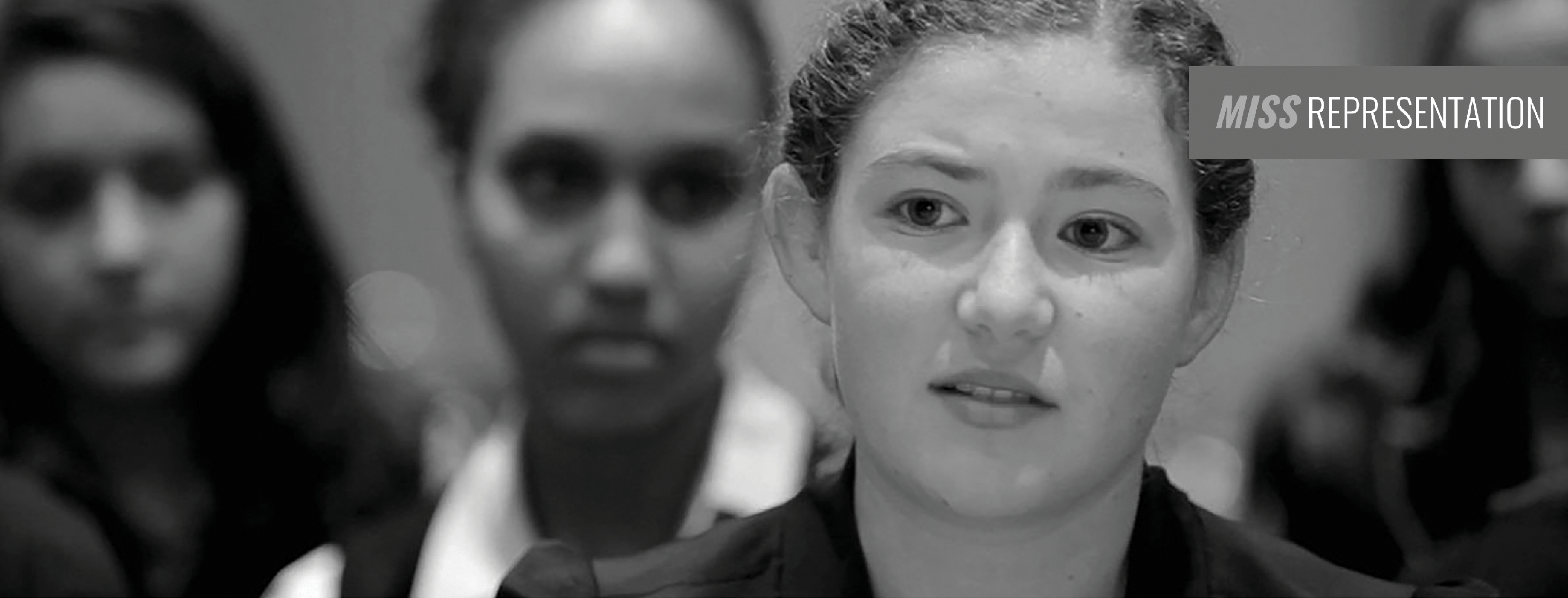 Black and white image showing a close-up of a woman with light skin and wavy hair looking slightly to the right. She is surrounded by three other blurred women in the background. A gray band with the text "Miss Representation" appears in the upper right corner, emphasizing its message.