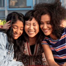 Photo of three characters from TV show Never Have I Ever sitting outside: Devi, Eleanor, and Fabiola.