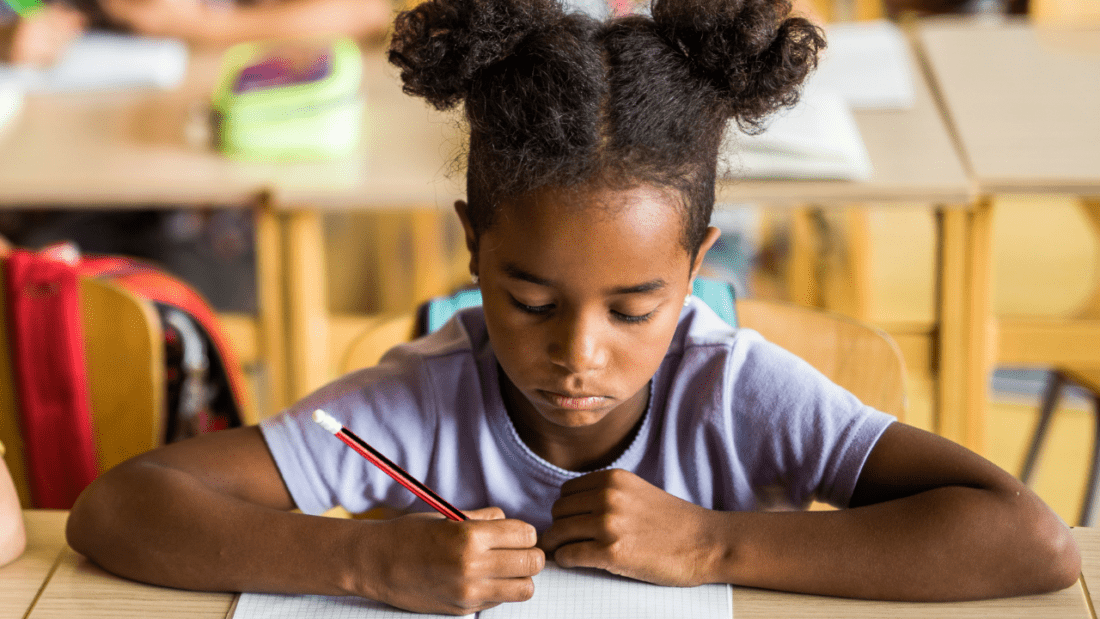 Elementary school student working at desk.