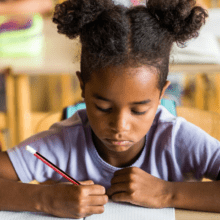 Elementary school student working at desk.