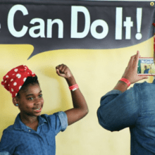 Girl posing as Rosie the Riveter