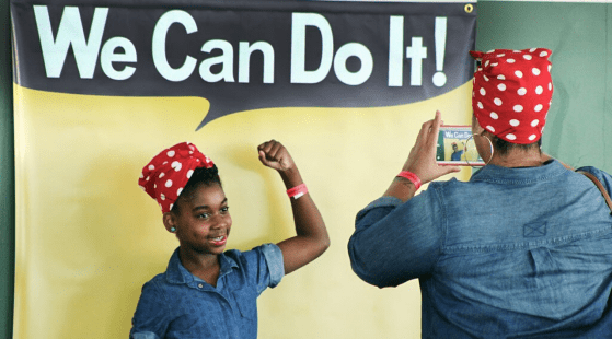 Girl posing as Rosie the Riveter