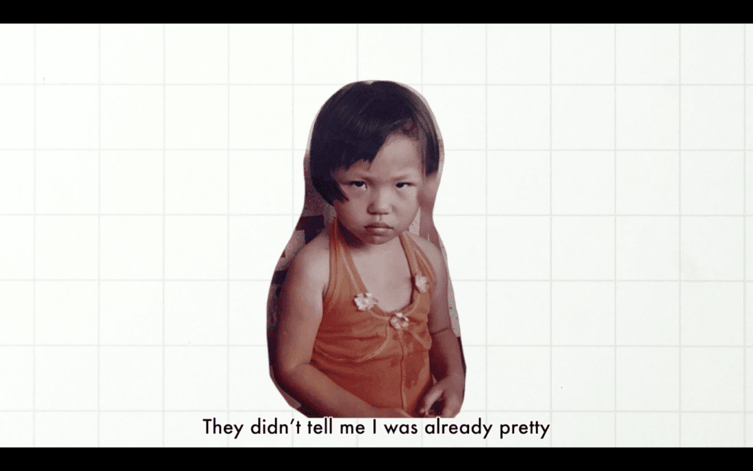 A child wearing an orange outfit stands against a plain background with a grid pattern, embodying the raw essence of documentary photography. The child has a serious expression, and text at the bottom of the image reads, "They didn't tell me I was already pretty.