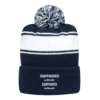 Introducing the *More One-of-A-Kind Beanies!*: A stylish navy blue and white knit beanie hat, adorned with a pom-pom on top. It features two white stripes and showcases the custom embroidered text "EMPOWERED women EMPOWER women" in white on the front of its turned-up cuff, making this unique beanie a perfect statement piece.