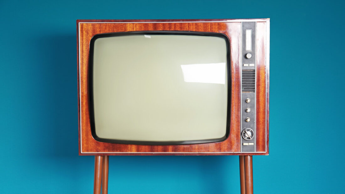 Vintage TV against color background