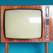 Vintage TV against color background