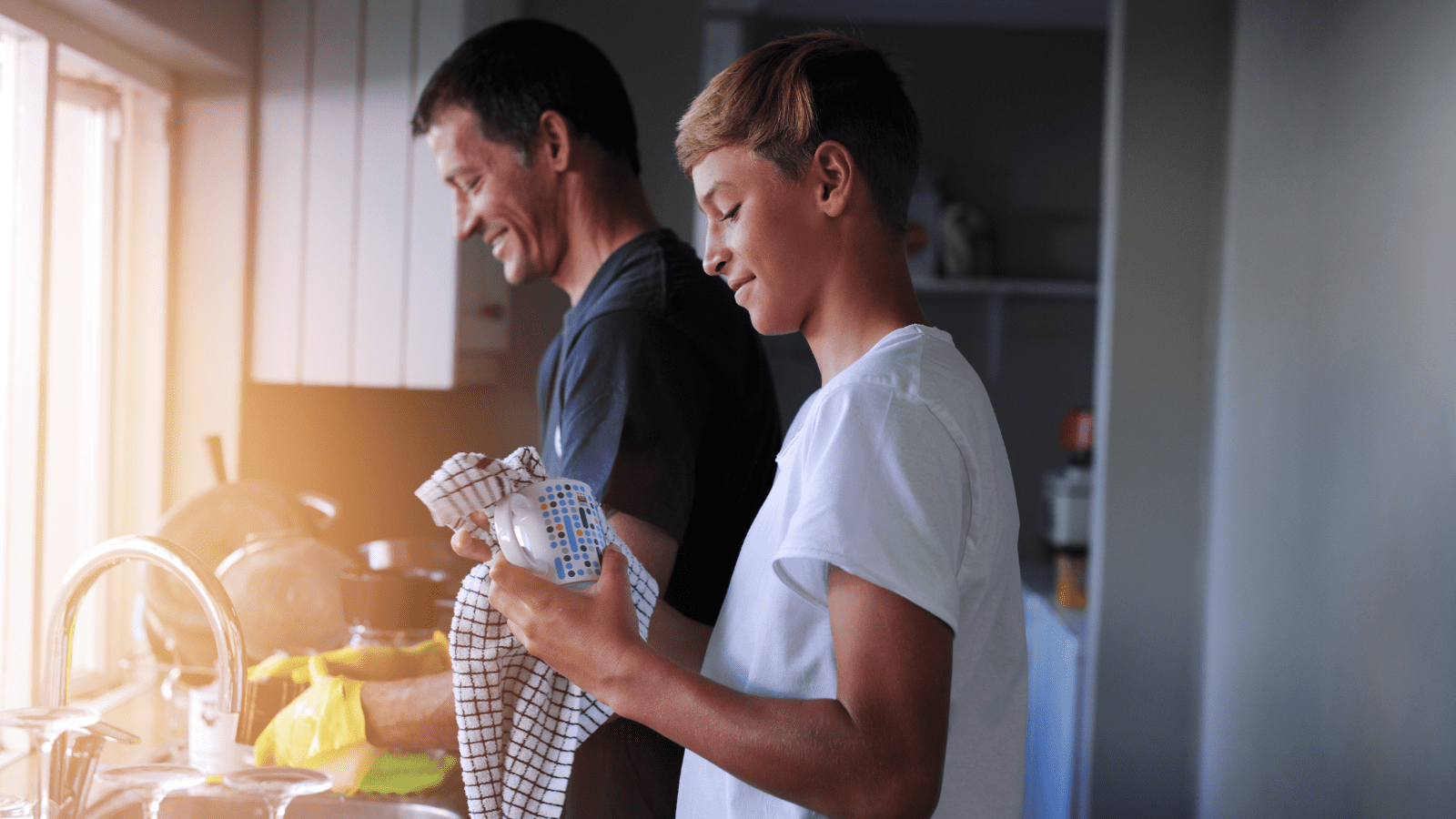 Two people washing and drying dishes.