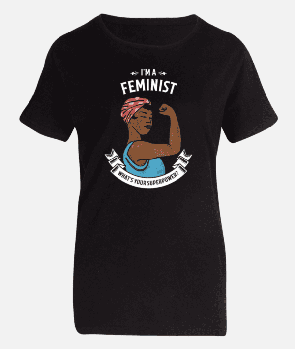 The "I'm a Feminist, What's Your Superpower?" T-Shirt depicts an illustration of a woman flexing her bicep and wearing a red and white headscarf. Above her, the text reads "I'm a Feminist Superpower," with a ribbon banner below stating "What's your superpower?" This design echoes the iconic Rosie the Riveter pose.